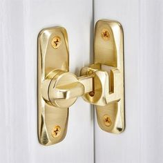 a close up of a door handle on a white door with gold hardware and knobs