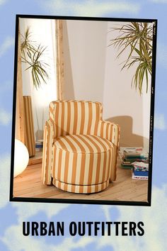 an orange and white striped chair sitting on top of a wooden floor next to a mirror