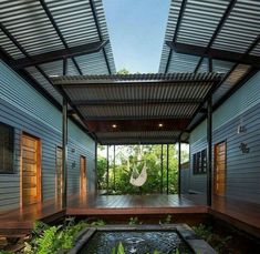 an outdoor room with a hammock in the center and water feature on the floor