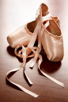 a pair of ballet shoes tied up on a table