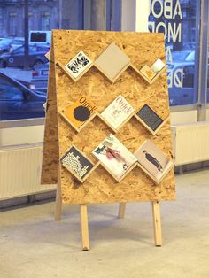 an easel made out of plywood with pictures on it