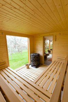 the inside of a wooden cabin with lots of wood slats on the floor and windows