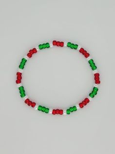 Christmas themed (silver-lined red, white ceylon, and silver-lined green) stretchy beaded bracelet for your wrist. Hand beaded bracelets make the perfect fashion accessory for wrist. Made with 6/0 seed beads. * Bracelet Length: about 7.5 inches * Custom orders are welcomed. Please send me a message for different colors and/or patterns. ** I would suggest rolling the stretchy bracelet onto your wrist rather than pulling the bracelet and stretching it out to put it on. This way the stretch bracele Christmas Jewerly Handmade, Winter Beads Bracelet, Christmas Bracelets Diy, Beaded Christmas Bracelets, Christmas Bracelets Beaded, Christmas Clay Bead Bracelets