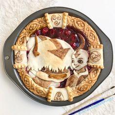 a plate with some food on top of it next to a fork and spoons