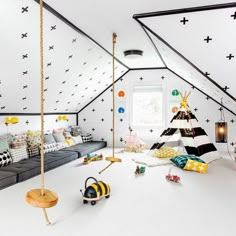 a room with white walls and black stars on the ceiling