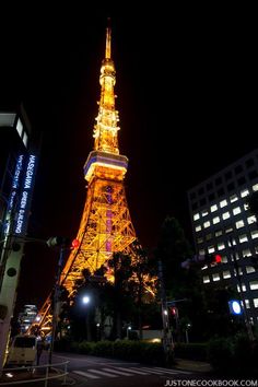 the eiffel tower is lit up at night