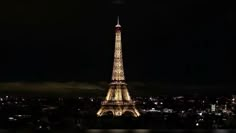 the eiffel tower is lit up at night