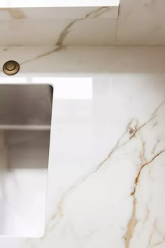 a close up of a bathroom sink under a faucet mounted on a wall