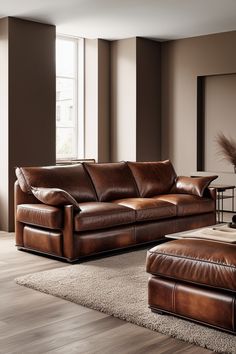 a brown leather couch and ottoman in a living room