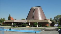 a large building with a pool in front of it