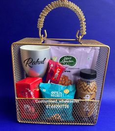 a basket filled with coffee and snacks on top of a blue background