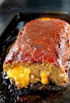 the meatloaf is covered with sauce and cheese on it's side, ready to be eaten