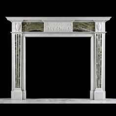 a white marble fireplace mantel with carvings on the front and sides, against a black background