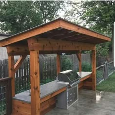 an outdoor bbq with grill and picnic table