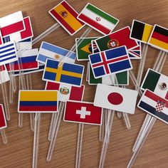 many flags are placed on toothpicks to be used as stickers or magnets