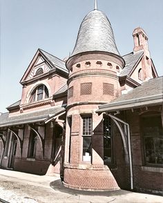 an old brick building with a clock tower on the front and side of it's roof