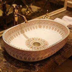 a fancy bowl shaped sink on top of a marble counter