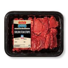 steak strips are in a plastic container on a white background with the label above them