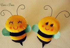 two stuffed bees sitting next to each other