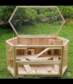 an outdoor chicken coop in the grass