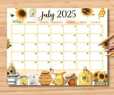 a calendar with sunflowers and other items on the table next to pencils