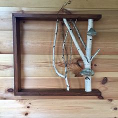 a wooden frame with branches hanging from it