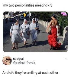 three women walking down the street with one woman wearing a red dress and two men in white