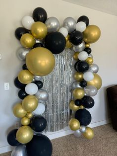 black, white and gold balloon arch