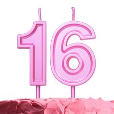 a pink birthday cake with the number sixteen on it's top and candles in the shape of numbers