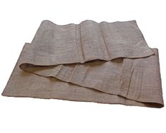 three pieces of linen folded on top of each other, with one piece laying down