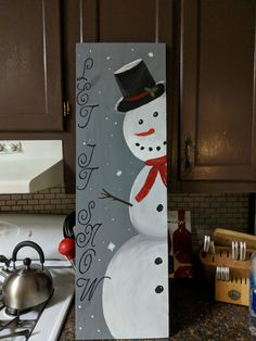 a painting of a snowman on a kitchen counter