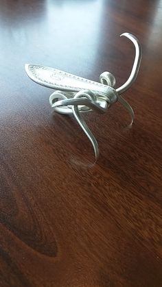 a metal object sitting on top of a wooden table