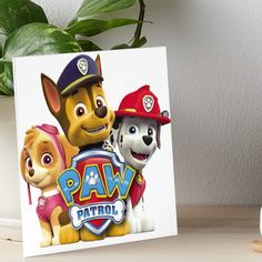 a paw patrol poster with two dogs and a fireman on it art board print