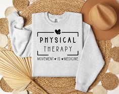 a sweatshirt with the words physical therapy on it next to straws and other items