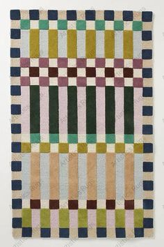 a multicolored rug with squares on it