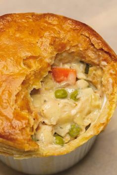 a chicken pot pie is opened to show the filling inside it's pastry shell