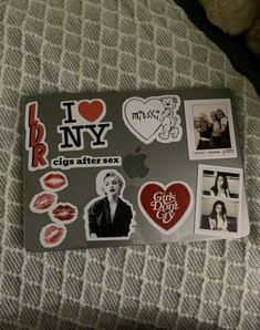 i love ny stickers on the back of a laptop computer case with pictures and hearts