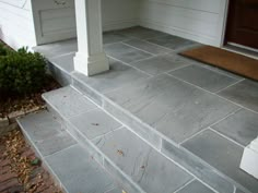 a porch with steps leading up to the front door