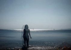 a person standing in the water at the beach