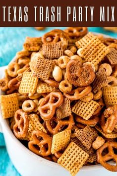 a bowl filled with cheetos and pretzels on top of a blue towel