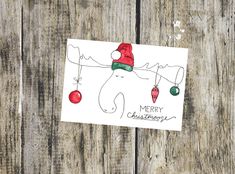 a christmas card with an elephant wearing a santa claus hat and holding a candy cane