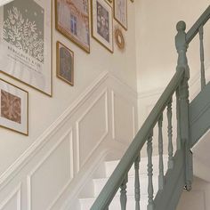 stairs with pictures on the wall above them