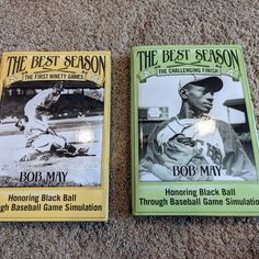 two baseball books laying on the floor next to each other in front of a carpet