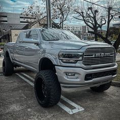 a silver ram truck parked in a parking lot