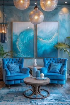 a living room with blue couches and chandeliers hanging from the ceiling above them