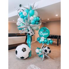 a room filled with balloons and soccer balls