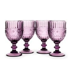 three purple glass goblets sitting next to each other