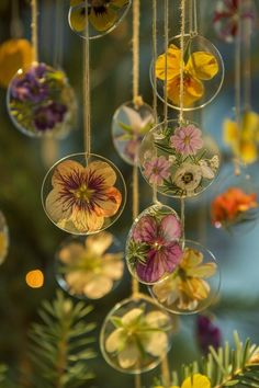 an assortment of hanging glass ornaments with flowers