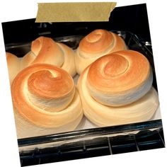 several rolls in a glass baking dish on top of a stove