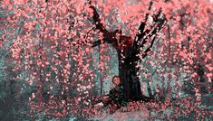 a woman sitting under a tree in the middle of a forest filled with pink leaves